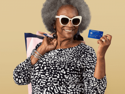 A smiling senior with a credit card and shopping bags