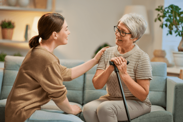 elderly patient comforted by caregiver
