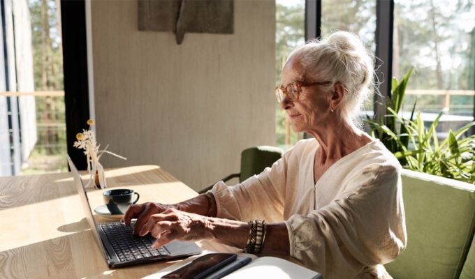 An old person using a computer