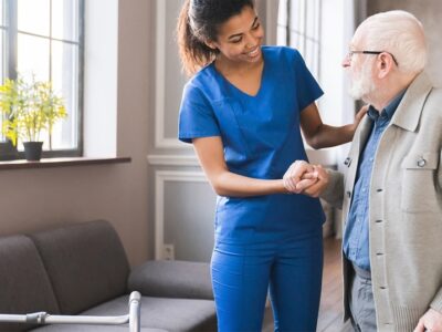 A nurse holding a person's hand.