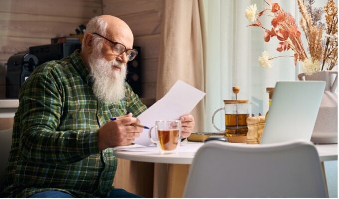 Old man reading a paper