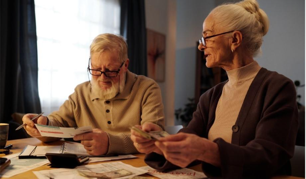 A person and person looking at paper